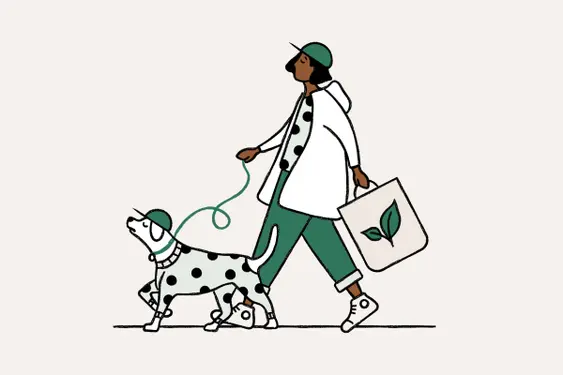 girl with a green hat walks her dog in a polka dot shirt